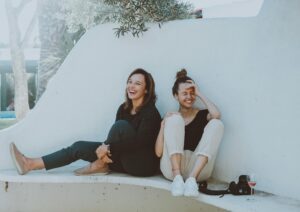 social anxiety 
Two women laughing together outdoors, enjoying leisure time and friendship.